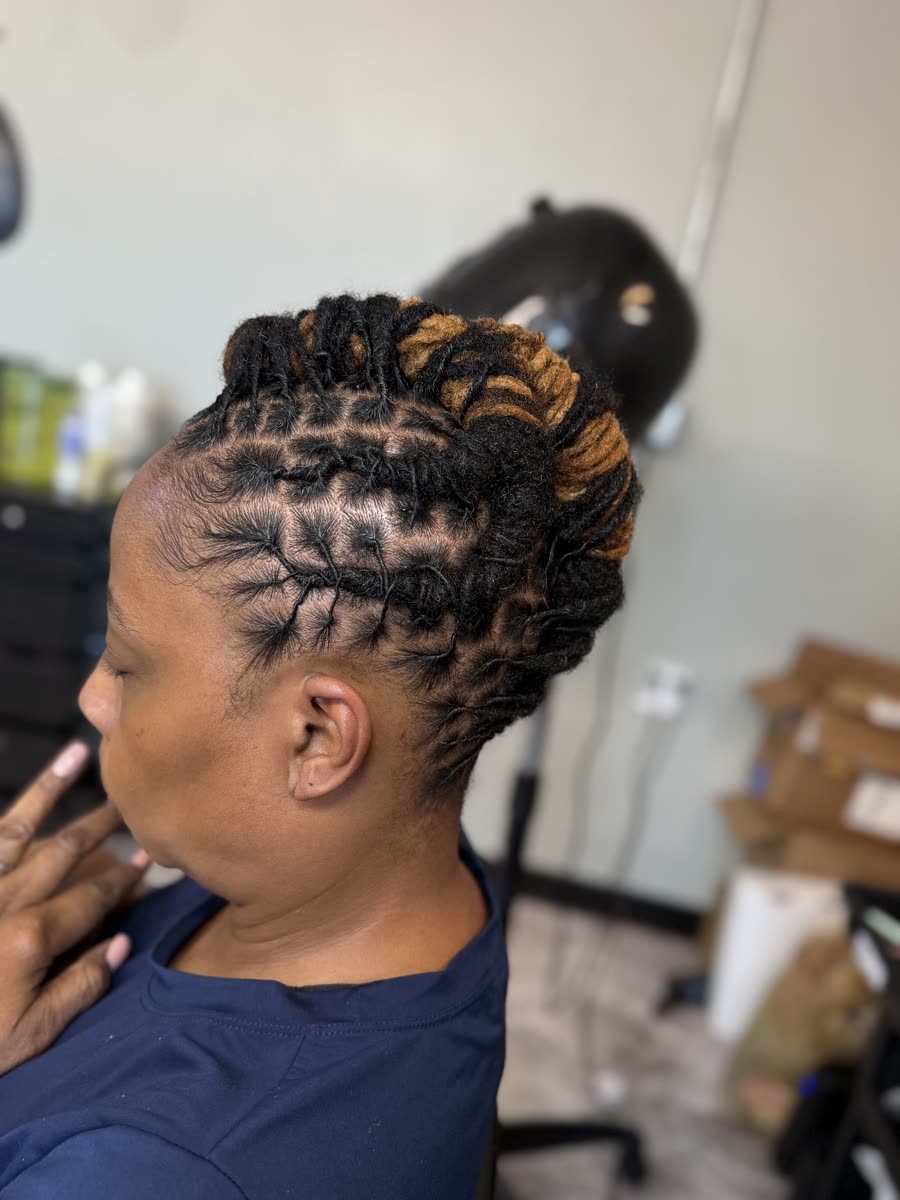 Loc updo with gold and blonde color accent bun